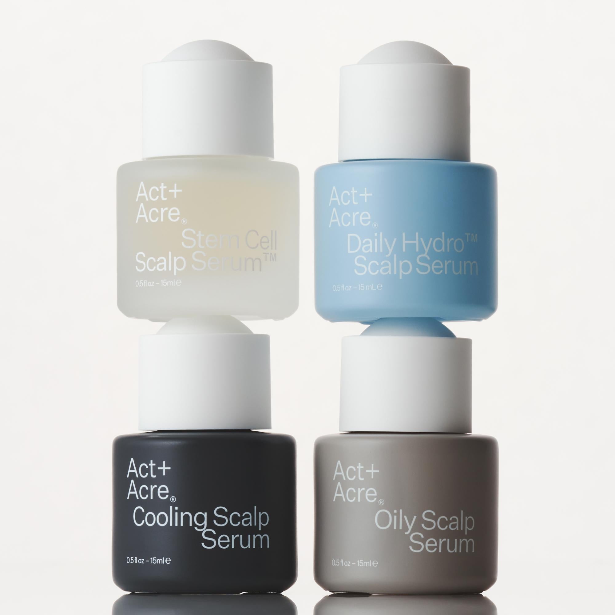 Four bottles of Act+Acre scalp serum in different colors on a white background