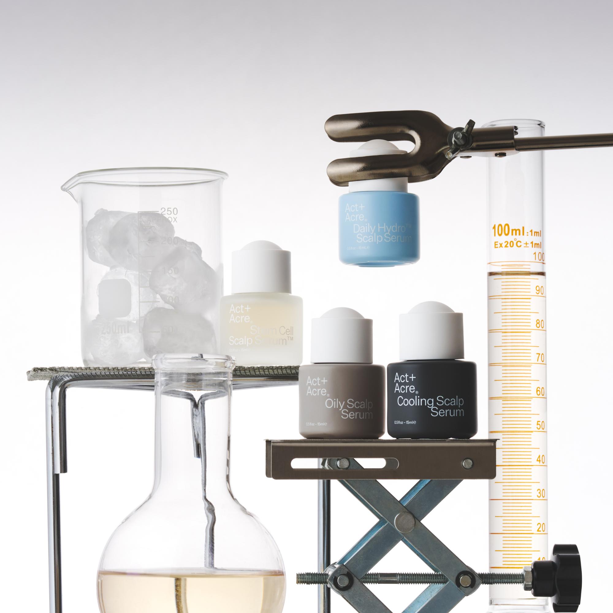 Skincare products on a lab stand with beakers and measuring instruments
