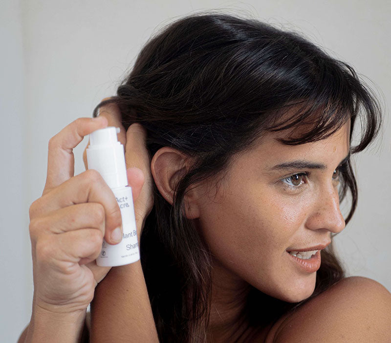 a woman holding a white object to her ear